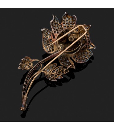 Diamonds, rubies, natural pearl, 18k gold and silver brooch