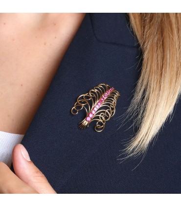 Red stones and gold brooch